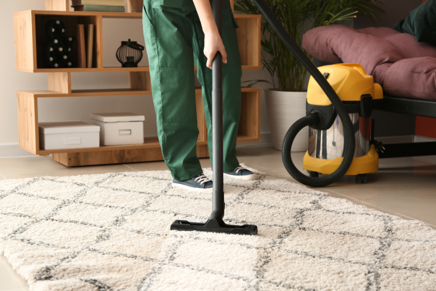 A durable vacuum cleaner cleaning a carpet—apart of our cost-effective tips for small business commercial cleaning