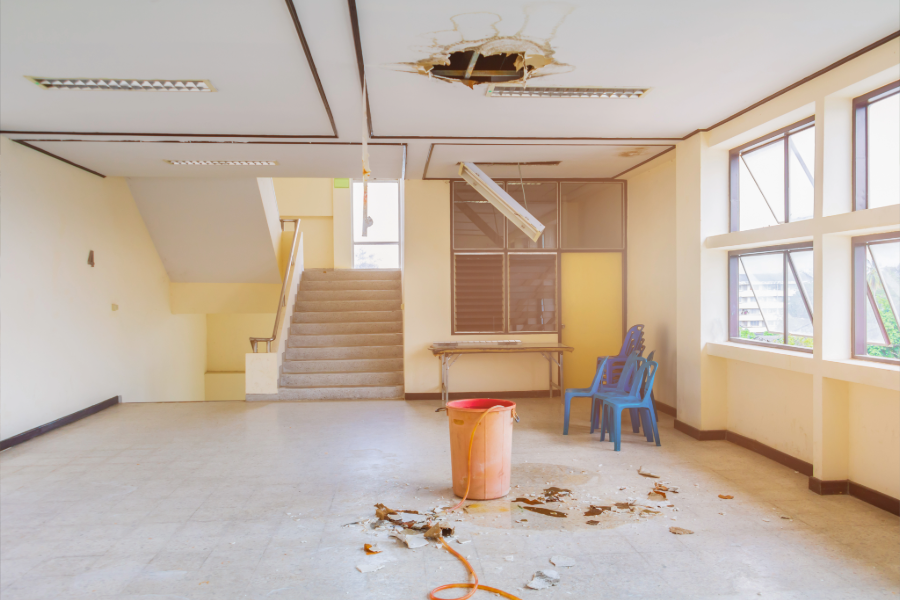 a cleaning emergency that shows a piece of the ceiling missing and spilled all over the floor in a commercial space in Kelowna